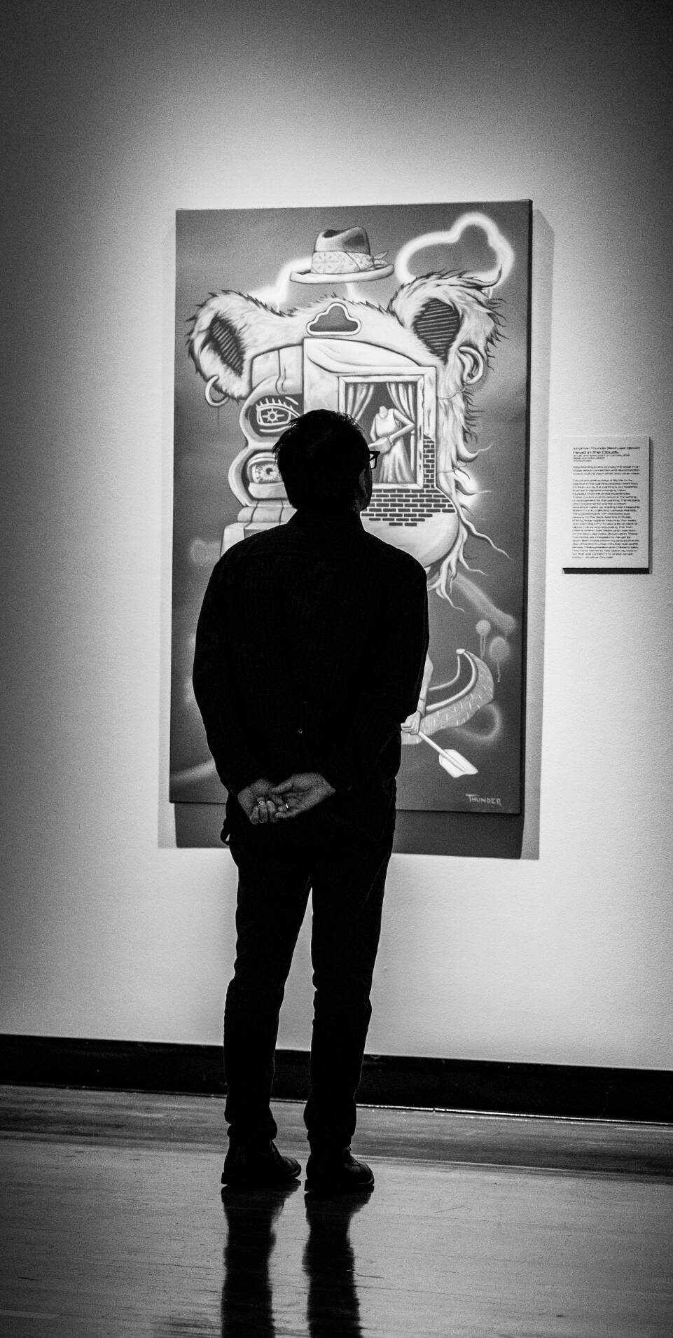 Stafford Smith, associate professor of photography, explores the exhibit, "Stories Reimagined: Artistic Narrative in the Digital Age," during the opening reception in the Haas Center for the Performing Arts gallery September 17.